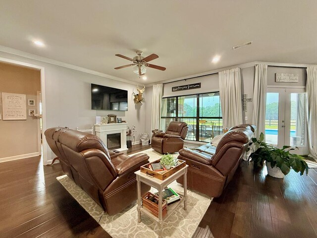 1243 Silcox Rd, Ashford, AL 36312 - living room with ceiling fan, wood-type flooring, a fireplace, baseboards, and crown molding