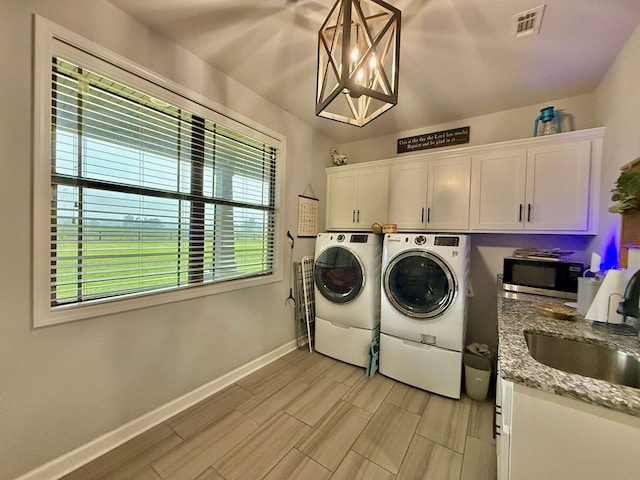 1243 Silcox Rd, Ashford, AL 36312 - laundry room featuring separate washer and dryer, cabinet space, baseboards, and wood finish floors