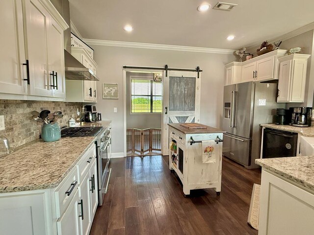 1243 Silcox Rd, Ashford, AL 36312 - kitchen featuring crown molding, a barn door, high end appliances, white cabinetry, and dark wood-style flooring