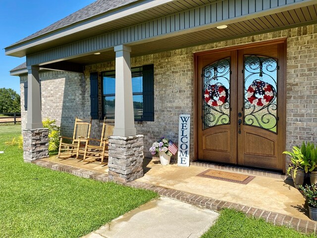 1243 Silcox Rd, Ashford, AL 36312 - view of exterior entry with a porch, brick siding, and french doors