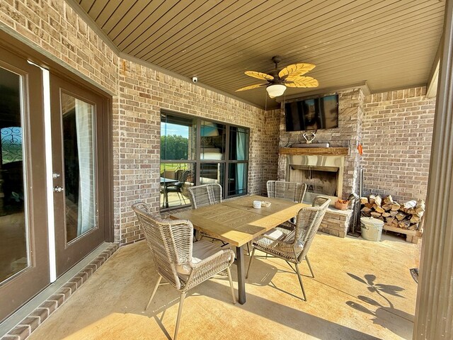 1243 Silcox Rd, Ashford, AL 36312 - view of patio / terrace with an outdoor fireplace, a ceiling fan, and outdoor dining area