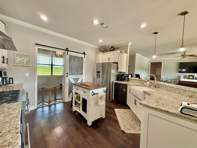 1243 Silcox Rd, Ashford, AL 36312 - kitchen featuring appliances with stainless steel finishes, ornamental molding, butcher block counters, white cabinetry, and a barn door