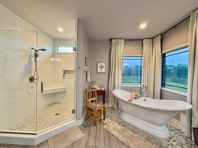1243 Silcox Rd, Ashford, AL 36312 - bathroom featuring a stall shower, wood finished floors, a soaking tub, baseboards, and recessed lighting