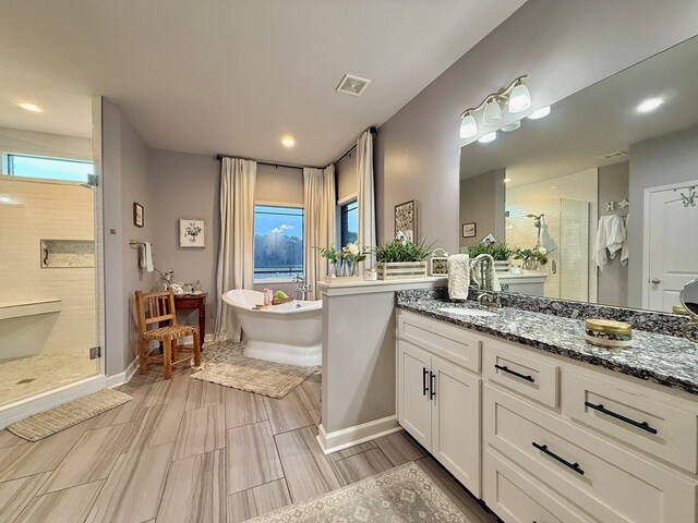 1243 Silcox Rd, Ashford, AL 36312 - full bath featuring a stall shower, vanity, a freestanding tub, baseboards, and recessed lighting
