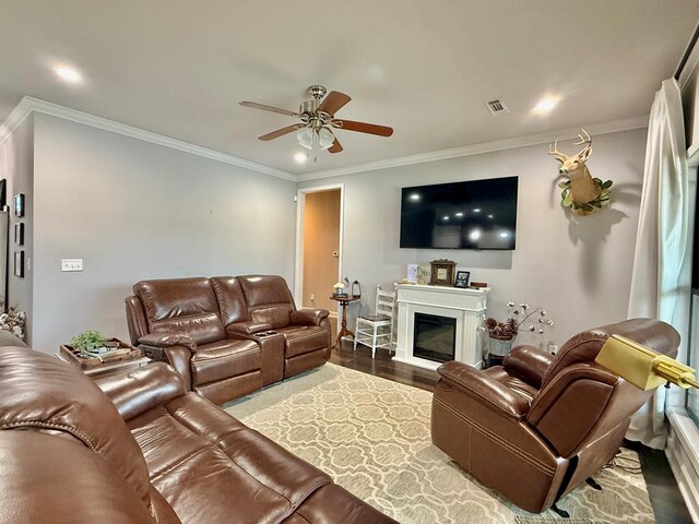 1243 Silcox Rd, Ashford, AL 36312 - living area featuring a ceiling fan, crown molding, wood finished floors, and a glass covered fireplace