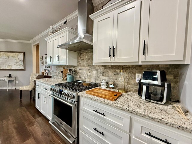 1243 Silcox Rd, Ashford, AL 36312 - kitchen with high end range, wall chimney range hood, ornamental molding, tasteful backsplash, and white cabinetry