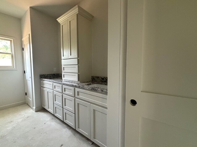 6161 Eddins Rd, Dothan, AL 36301 - bathroom with double vanity, concrete floors, and baseboards