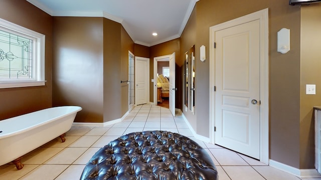 bathroom with tile patterned flooring, a washtub, and ornamental molding