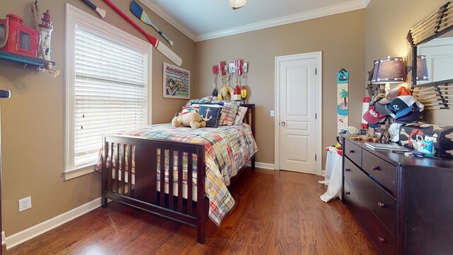 bedroom with dark hardwood / wood-style floors and crown molding