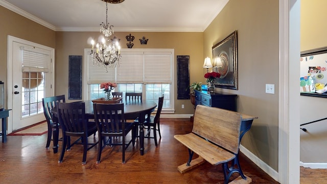 dining room featuring crown molding, dark hardwood / wood-style floors, and a notable chandelier