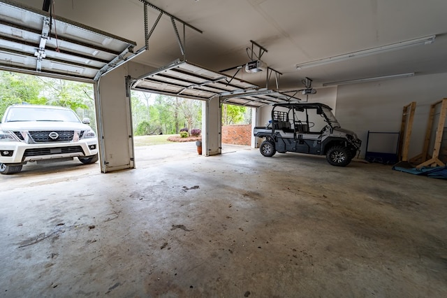 garage with a garage door opener and a carport