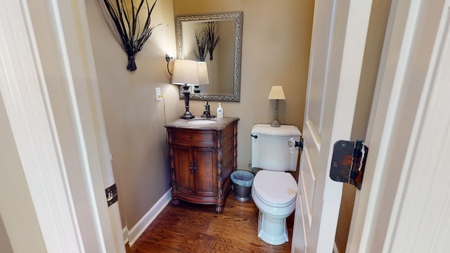 bathroom with hardwood / wood-style floors, vanity, and toilet