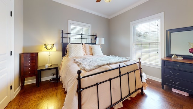 bedroom featuring ceiling fan, dark wood-type flooring, and ornamental molding