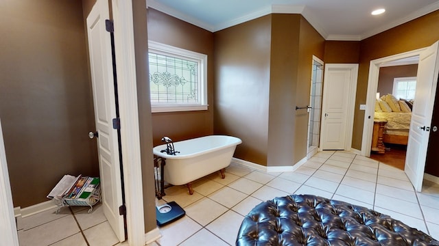 bathroom featuring tile patterned floors, crown molding, and a washtub