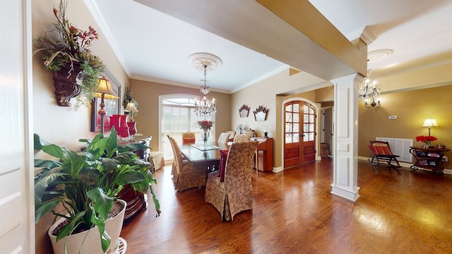 dining space with french doors, an inviting chandelier, dark hardwood / wood-style floors, decorative columns, and crown molding