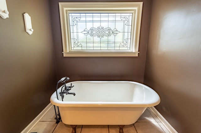 bathroom with tile patterned floors and a tub