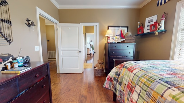 bedroom featuring crown molding and hardwood / wood-style floors