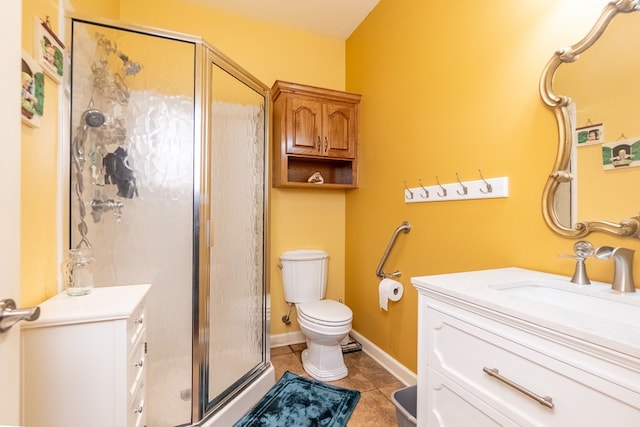 bathroom featuring tile patterned floors, vanity, toilet, and a shower with door