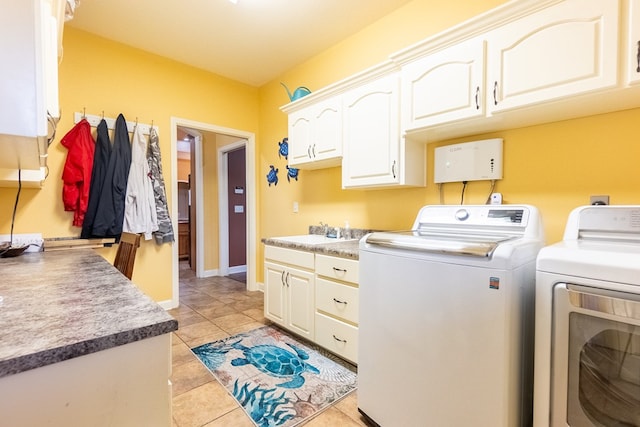 laundry room featuring washer and dryer, cabinets, light tile patterned floors, and sink