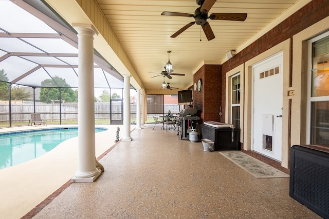 view of swimming pool with a lanai, a patio area, and ceiling fan