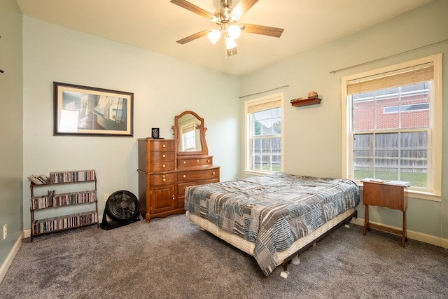 bedroom featuring dark carpet and ceiling fan