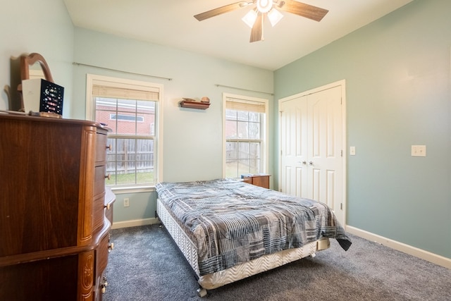 bedroom featuring ceiling fan, a closet, and dark colored carpet