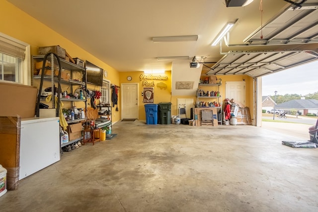 garage featuring a workshop area and a garage door opener