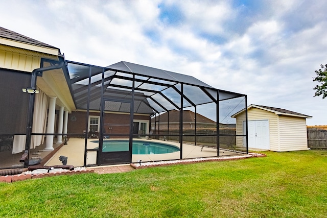 view of swimming pool with a lanai, a patio area, a lawn, and a shed