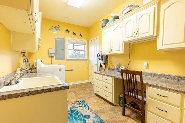 clothes washing area featuring cabinets, electric panel, sink, washer and dryer, and light tile patterned floors