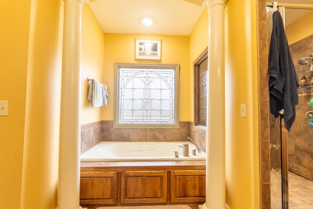 bathroom featuring plus walk in shower and plenty of natural light