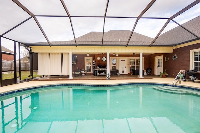 view of pool featuring ceiling fan, a patio area, and a lanai