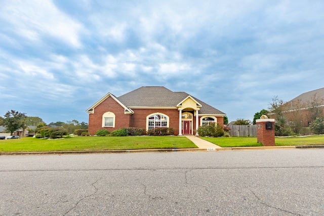 single story home featuring a front lawn