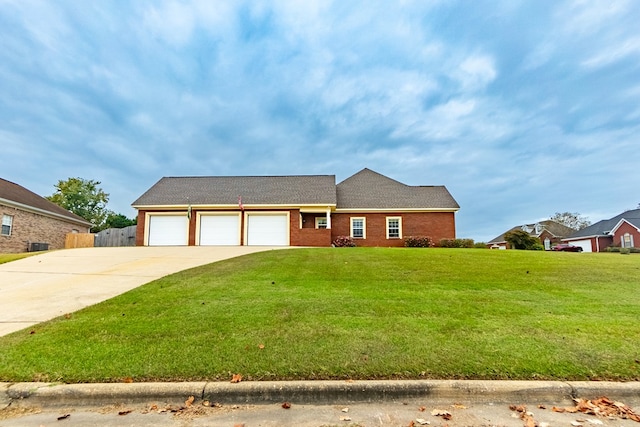 ranch-style house with a garage and a front lawn