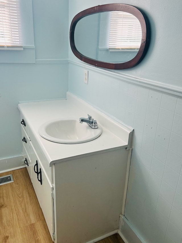 403 W Main St, Samson, AL 36477 - bathroom with wood finished floors, vanity, and wainscoting