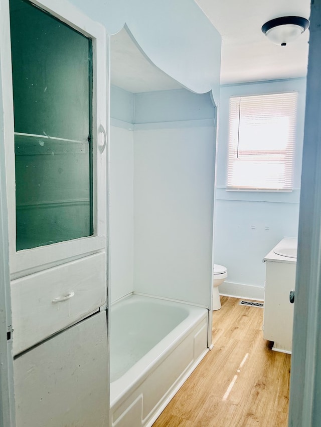 403 W Main St, Samson, AL 36477 - bathroom featuring wood finished floors, vanity, and shower / tub combination