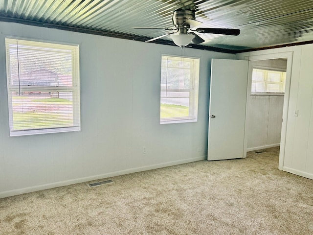 403 W Main St, Samson, AL 36477 - unfurnished bedroom featuring light carpet, multiple windows, a closet, and a ceiling fan