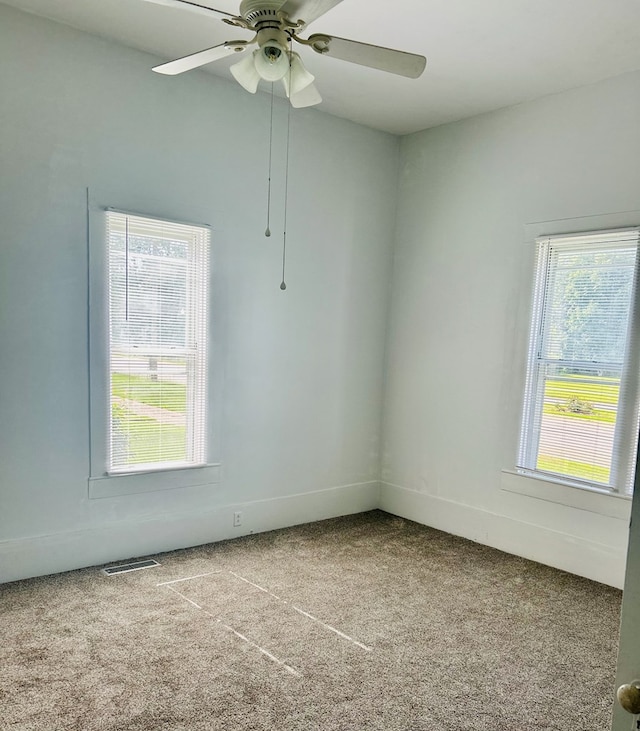 403 W Main St, Samson, AL 36477 - carpeted empty room with a ceiling fan