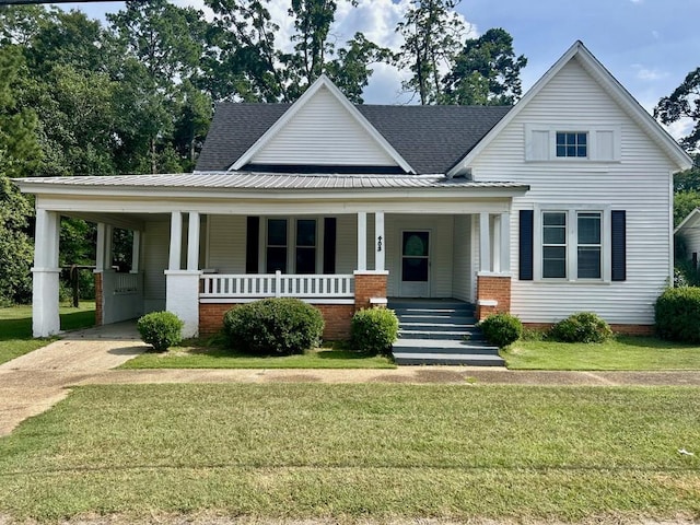 403 W Main St, Samson, AL 36477 - view of front of home with covered porch, a front lawn, an attached carport, and roof with shingles