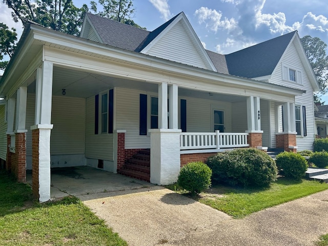 403 W Main St, Samson, AL 36477 - view of front of house featuring driveway, an attached carport, covered porch, and roof with shingles