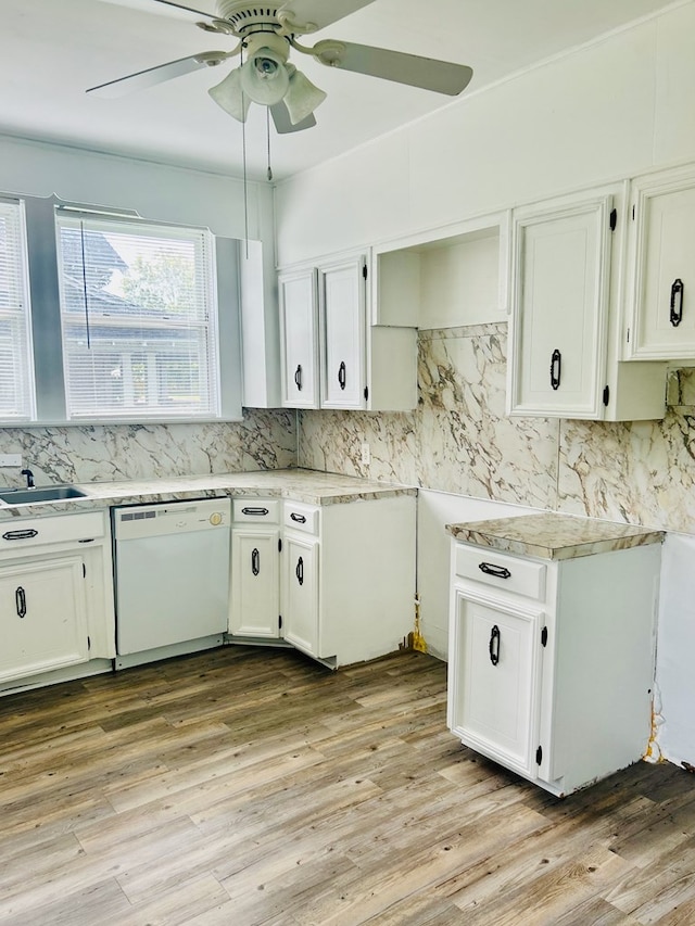 403 W Main St, Samson, AL 36477 - kitchen with white dishwasher, tasteful backsplash, light countertops, a ceiling fan, and white cabinetry