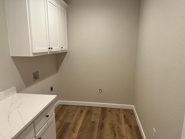 laundry room with hookup for a washing machine, baseboards, cabinet space, electric dryer hookup, and dark wood-type flooring