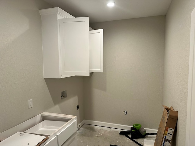 clothes washing area with cabinet space, electric dryer hookup, hookup for a washing machine, and baseboards