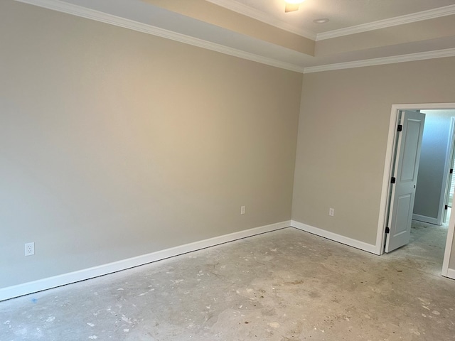 empty room with crown molding, baseboards, and concrete flooring