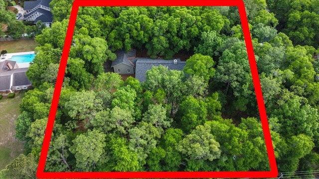 birds eye view of property featuring a view of trees