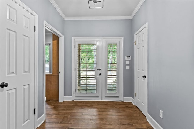 doorway with crown molding, dark wood-style flooring, and baseboards