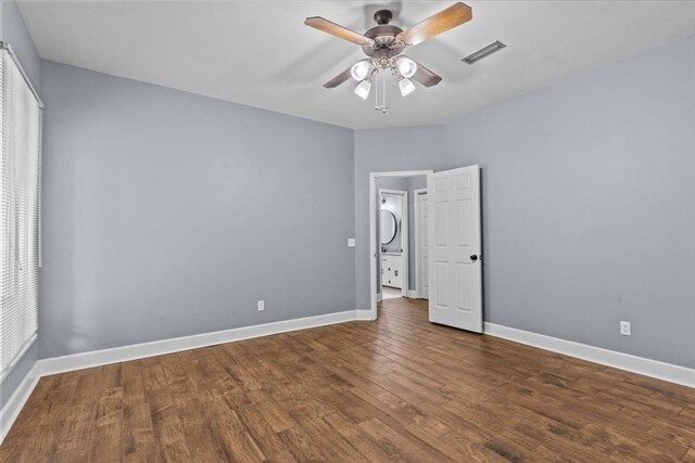 unfurnished bedroom with wood finished floors, visible vents, ceiling fan, and baseboards