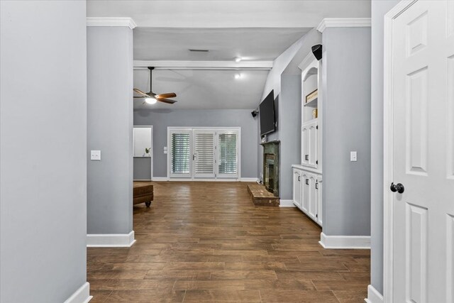 corridor featuring crown molding, dark wood finished floors, beam ceiling, and baseboards