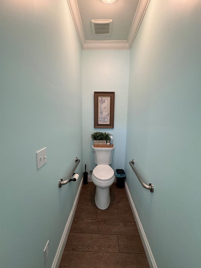 bathroom featuring wood finished floors, visible vents, toilet, ornamental molding, and baseboards