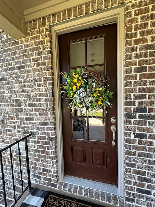 entrance to property with brick siding