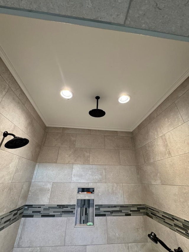 interior details featuring recessed lighting, a tile shower, and ornamental molding